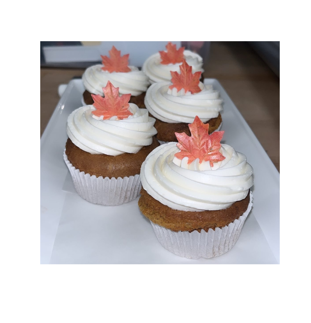 Autumn spice cupcakes with cream cheese frosting and maple leaf sugar decorations