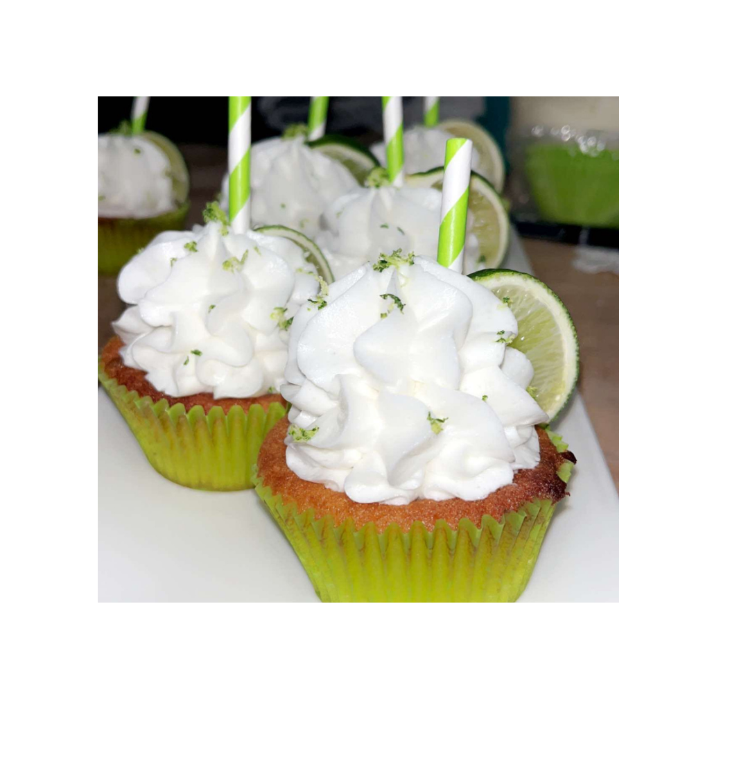Margarita cupcakes with fluffy white frosting, lime wedge and striped straw